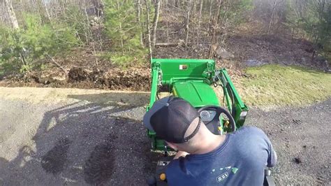 john deere digging a ditch